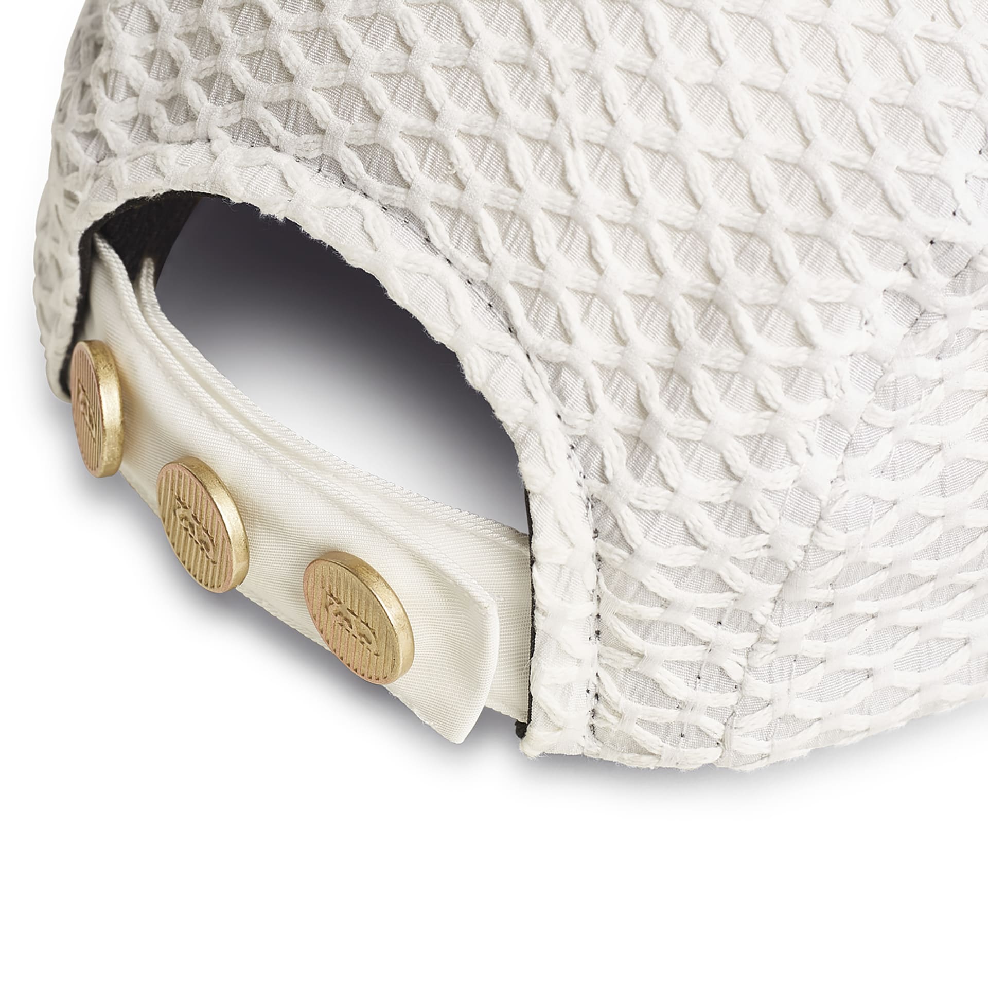 Boné off-white com tela vazada; botão decorativo dourado e faixa interna clara.